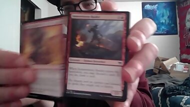Cute Young Nerd Opening a Pack of Magic the Gathering Cards